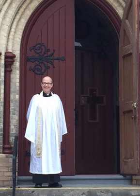 Father Rob Ross at the doors of the church